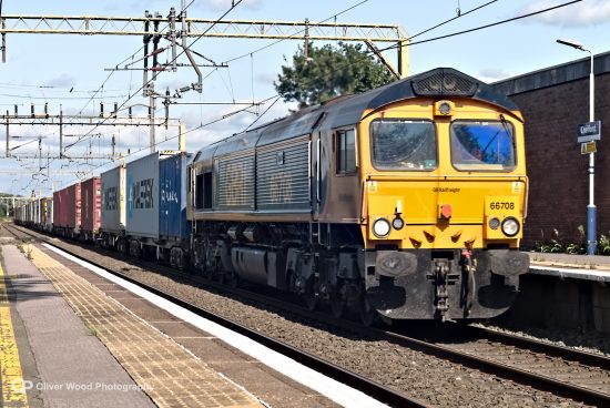 freight train passing through a station 