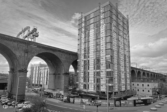 Black and white photo of new tower block and railway viaduct